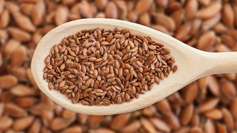 Wooden spoon filled with flaxseeds 