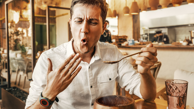 man eating hot food