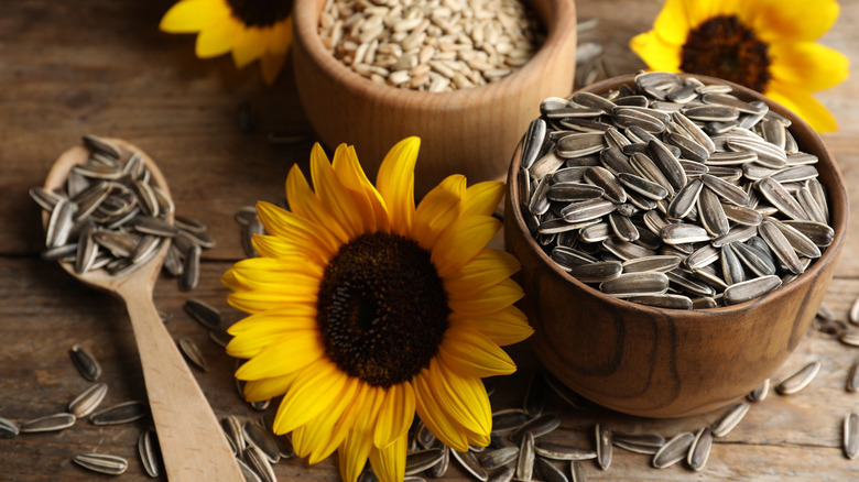 Sunflowers and bowls of sunflower seeds