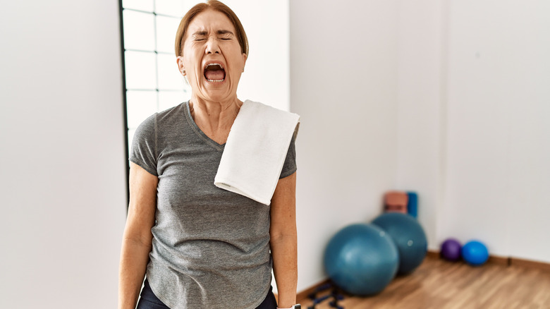 older woman upset screaming in gym