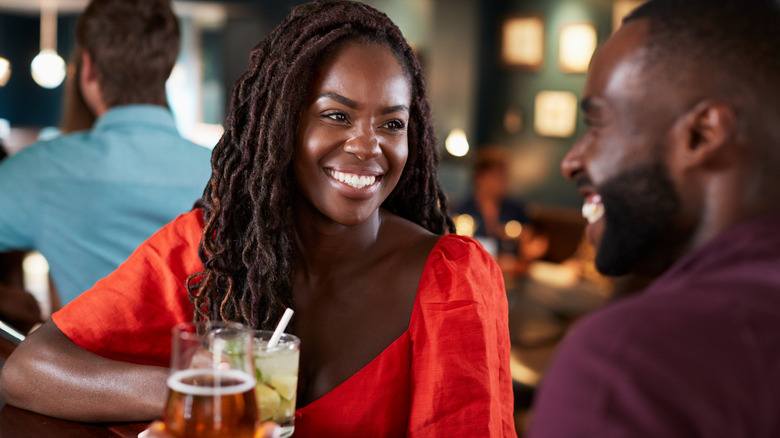 happy african american couple on a date with beers