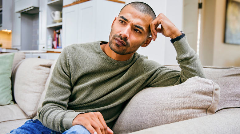 Tired man sitting on the couch