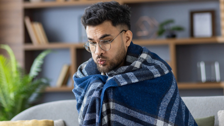 Man wrapped up in a blanket