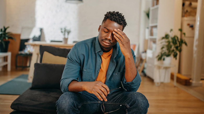 Man clutching his head in pain