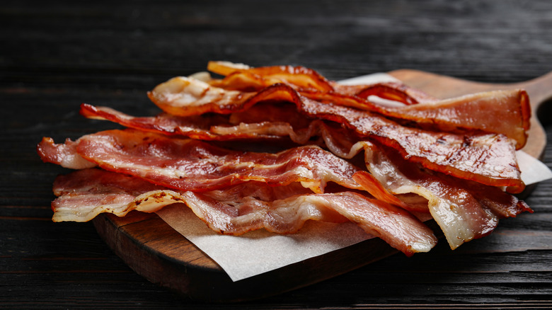 a wooden slab with fried bacon