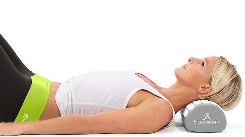 Woman lying on ProsourceFit Acupressure Mat