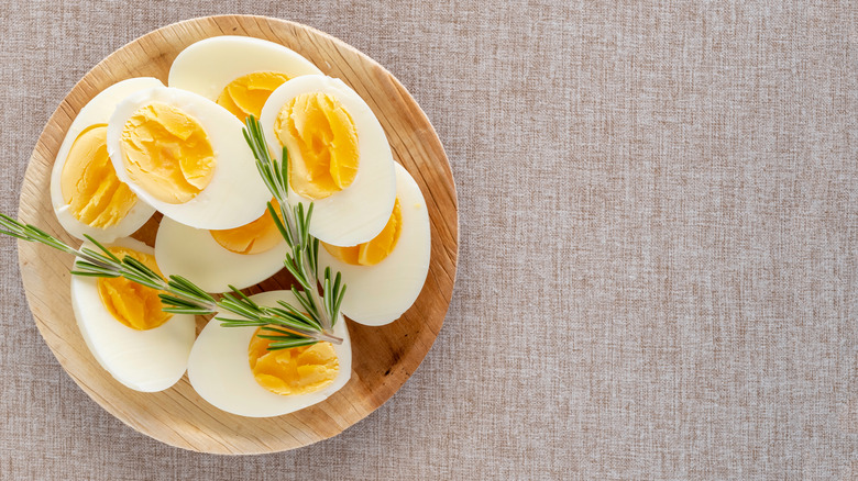 Boiled eggs in wooden bowl
