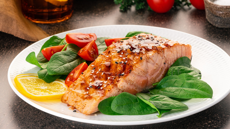 salmon on plate of vegetables