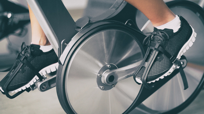 person pedaling on a stationary bike