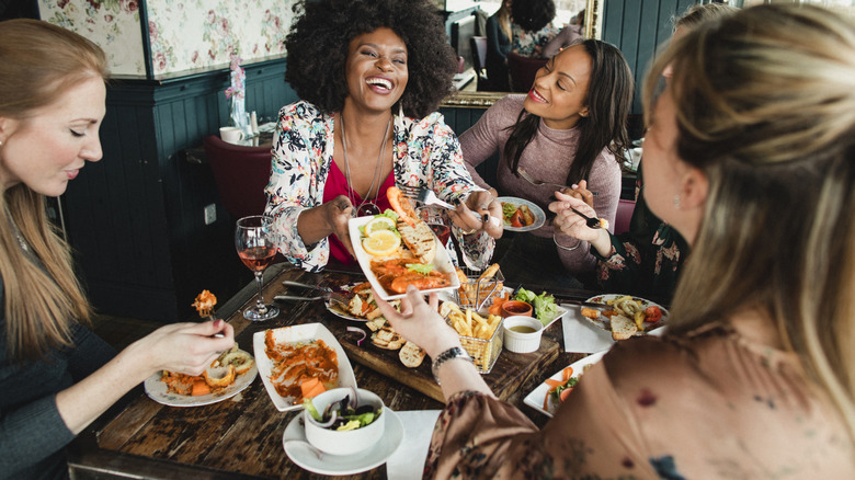 A group of women eating at a restaurant