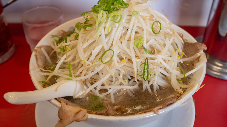 A close up of a Japanese dish topped with sprouts