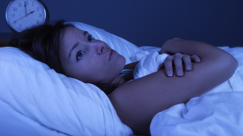 Woman laying awake in bed