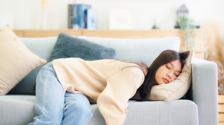 exhausted woman laying in a couch
