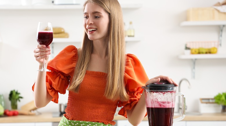 Young woman with a glass of beet juice