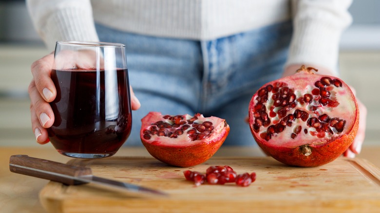 Woman holding a glass of pomegranate juice