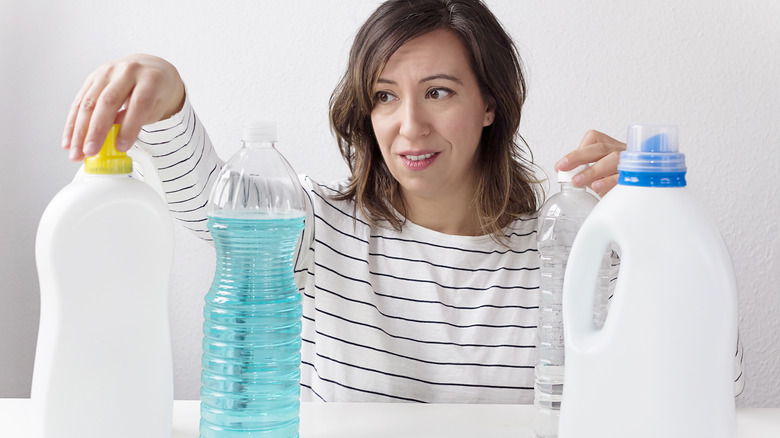 Woman with household cleaning supplies