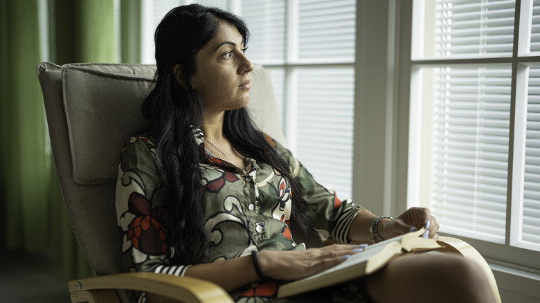 Woman sitting at home alone