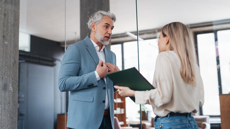 Woman being scolded by boss in office