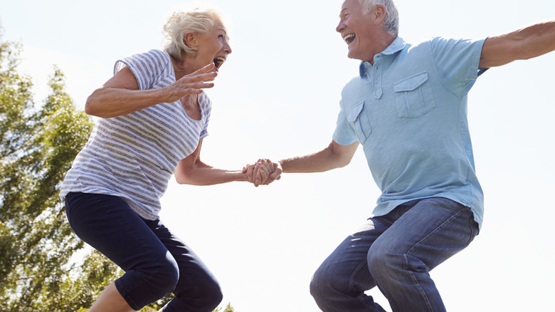 older couple trampolining