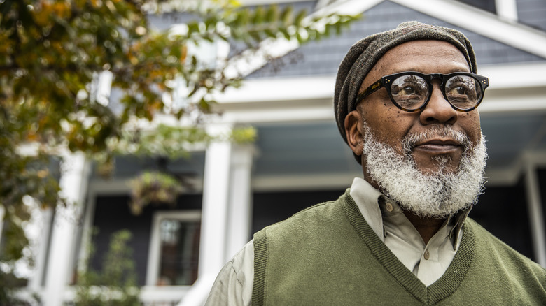 Portrait of senior African American man in front of his home