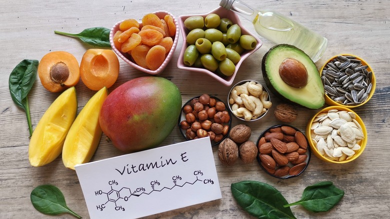 Top view of various vitamin E-rich foods, like, nuts, seeds, and oils