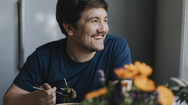 Smiling man eating a healthy meal