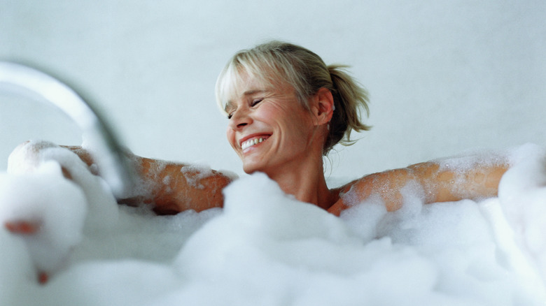 Woman in buddle bath cleaning herself