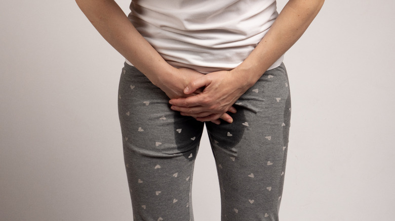 A woman wearing pants covering her crotch area