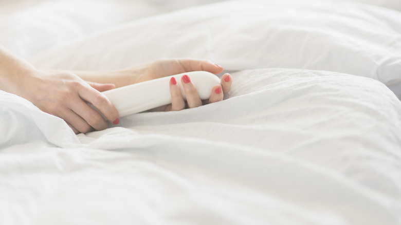 A woman's hands holding a massager