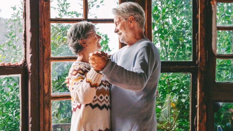 Elderly couple dancing together