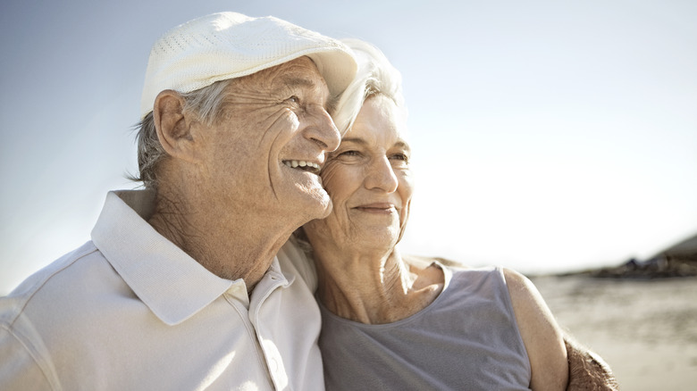 Older couple relaxed and happy on beach