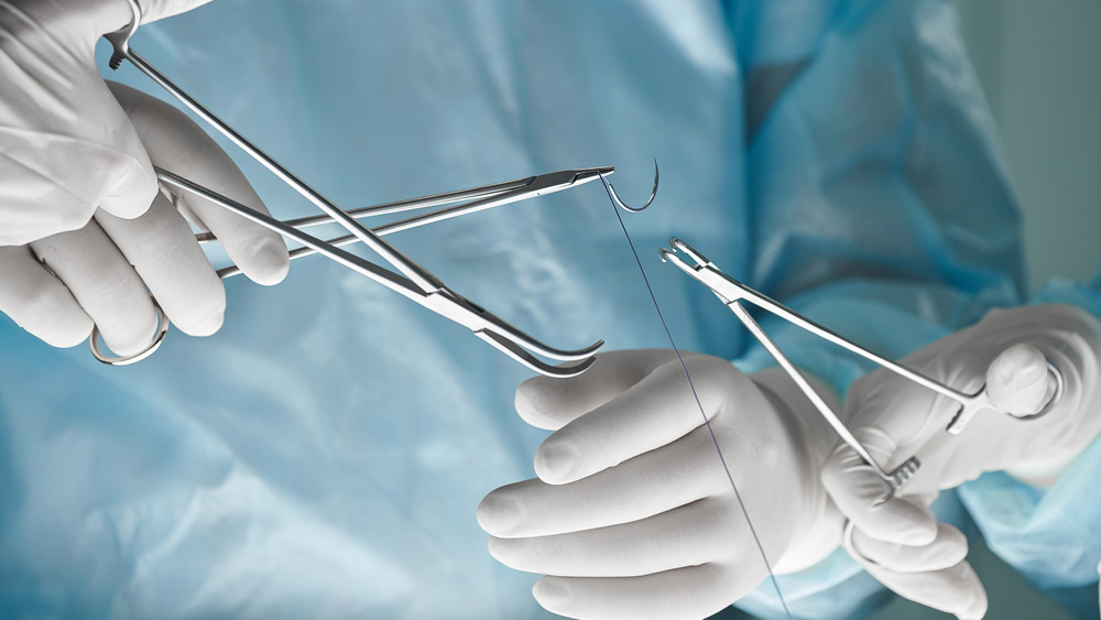 Surgeons handle sutures