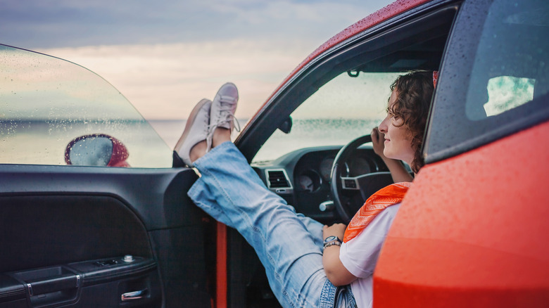 a woman in her car alone looking at a view 