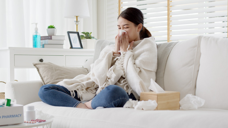 woman sick at home on couch