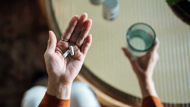 overhead shot of woman's hand holding large caplets