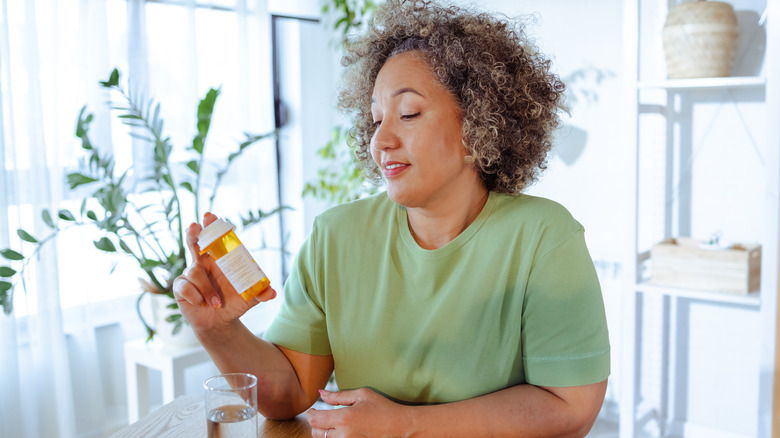 woman checking her medication bottle