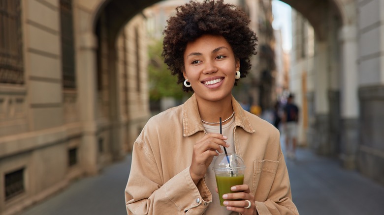 woman holding a detox drink