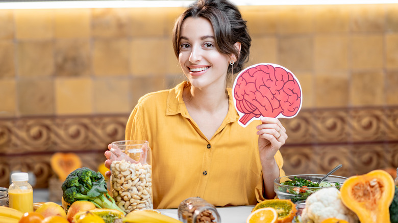 woman holding picture of brain 