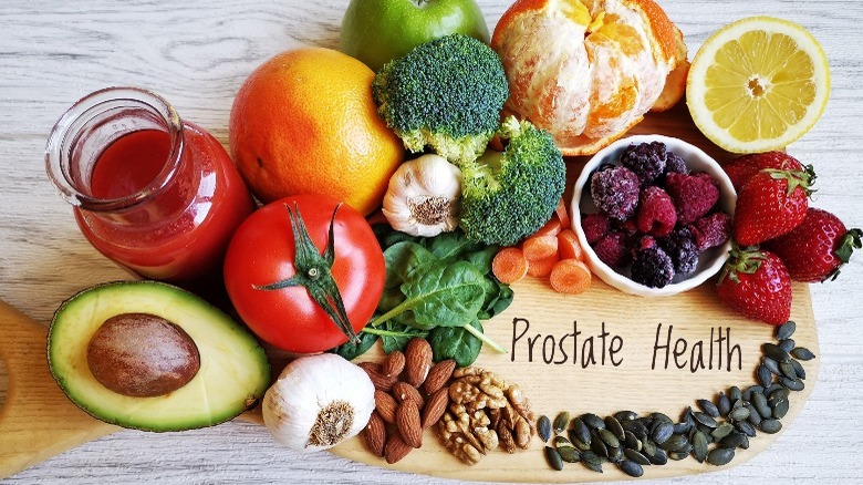 fruits and vegetable surround a wood cutting board that reads 'prostate health'