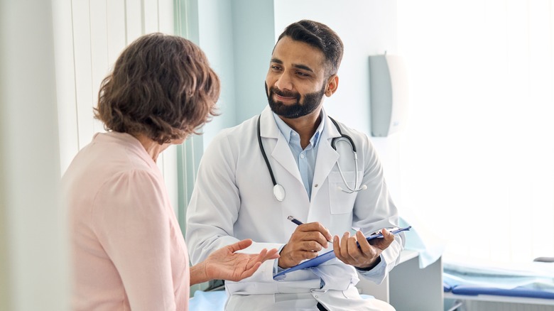 Woman talking to doctor 