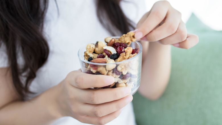 woman eating dried fruit and nuts