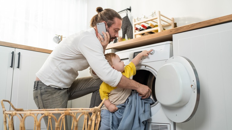 Dad doing laundry with child