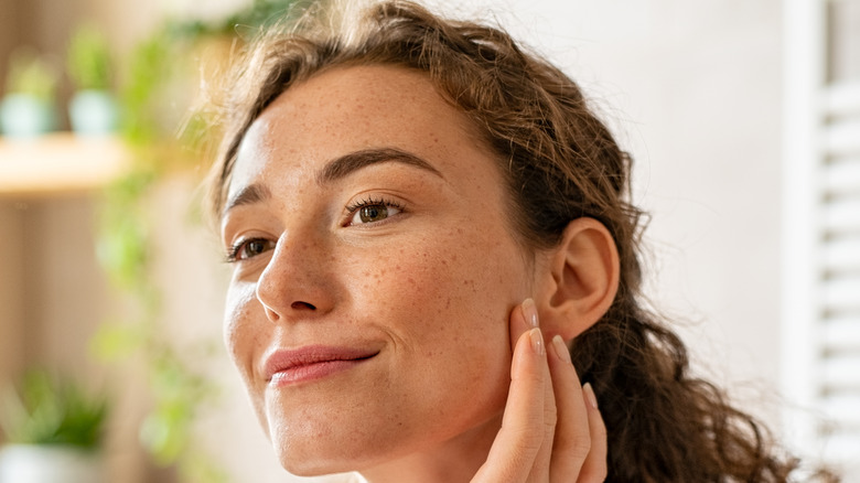 Woman examining her skin