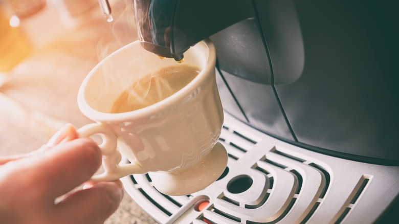 Coffee machine pouring coffee into cup