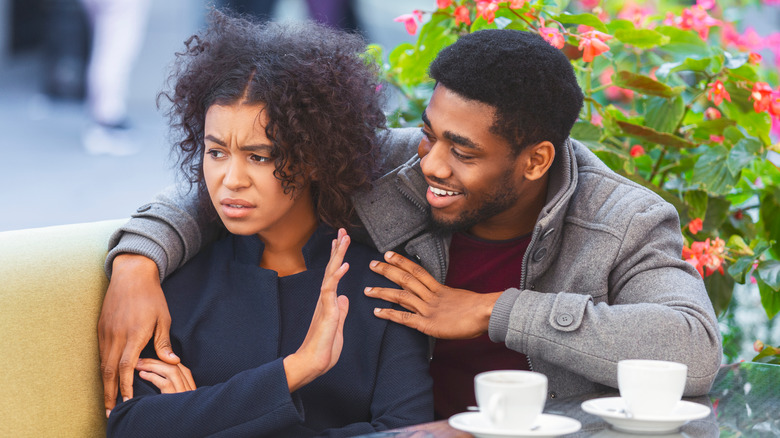 man tries to cheer up woman