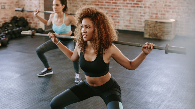 Woman doing barbell squat