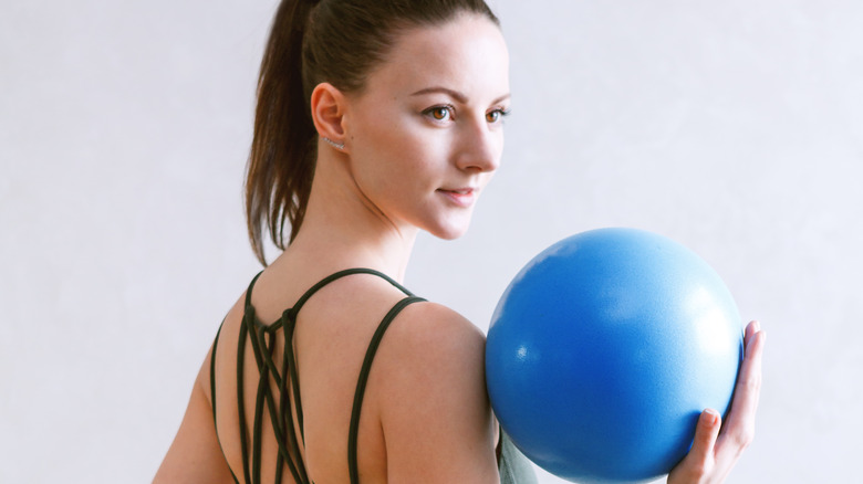 Woman holding balance ball