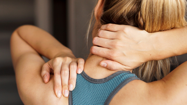 Woman experiencing pain in her neck and back