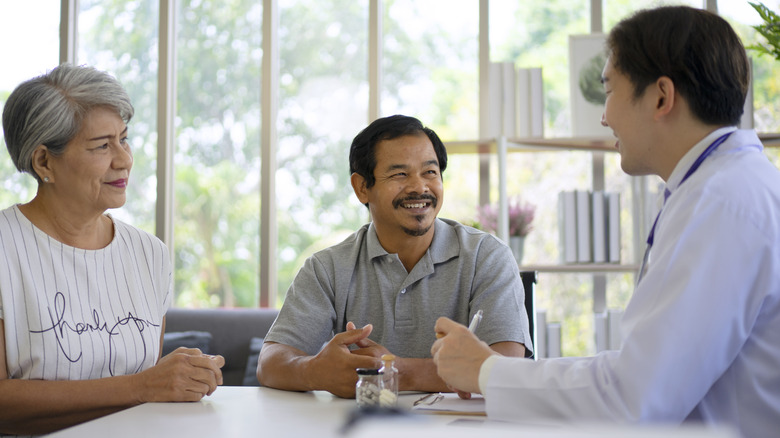 Doctor speaking to a couple