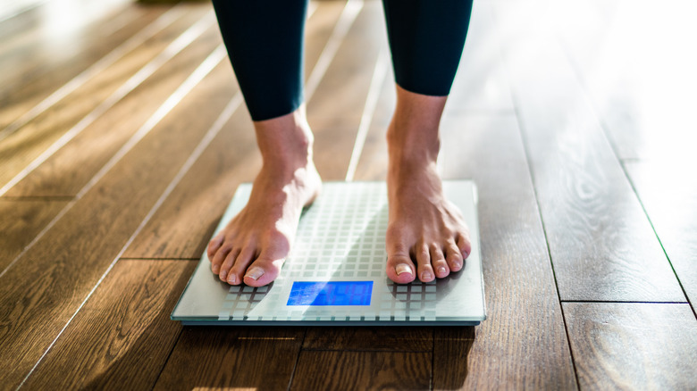 bare feet on weighing scale